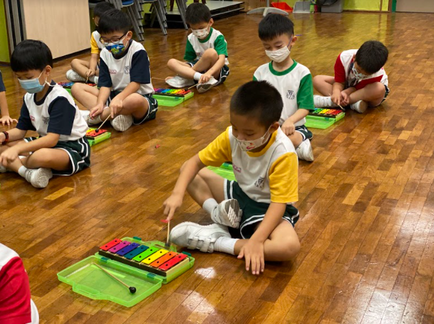 Primary 1 pupils learning to play a song on the resonator bells